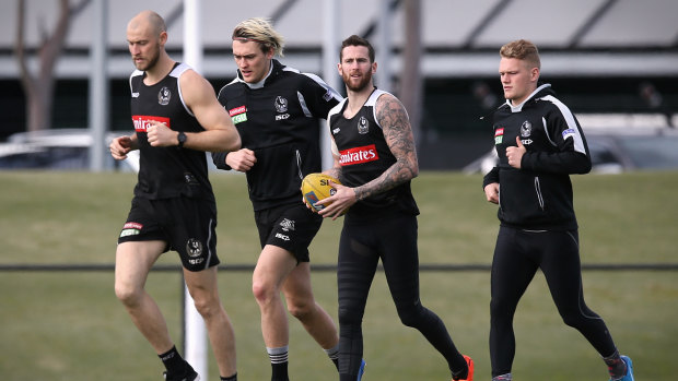 (From left) Ben Reid, Darcy Moore, Jeremy Howe and Adam Treloar on the training track on Monday.