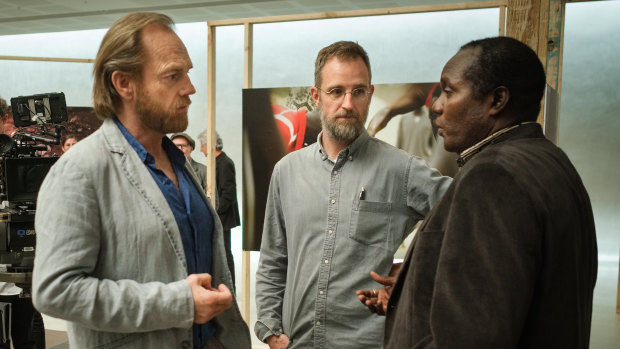 Ben Lawrence (centre) directs Hugo Weaving  and Andrew Luri during the shoot for Hearts and Bones at St Barnabas Anglican Church in Sydney. 