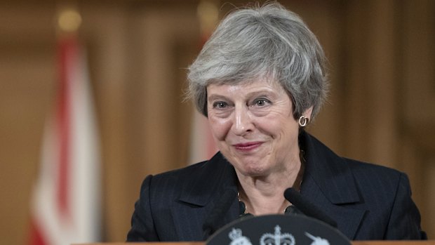 Theresa May listens to a question from reporters as she delivers a statement on the Brexit agreement during a news conference inside number 10 Downing Street in London.