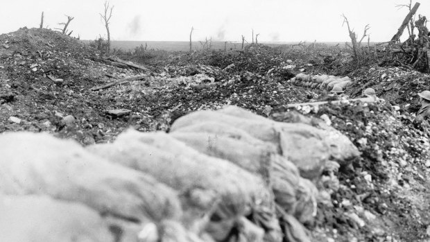 Tin-hatted soldiers can be seen in a trench amid the devastation of the Mouquet Farm battlefield.