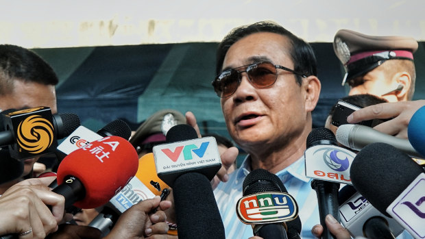 Thailand's PM Prayut Chan-o-cha addresses the waiting media after casting his vote on Sunday. 