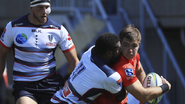 Rebels' Marika Koroibete struggles to stop Sunwolves' Gerhard van den Heever in Tokyo. 