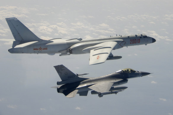 Tension in the skies. A Taiwanese F-16 flies near a Chinese bomber as it passes near Taiwan in 2020. 