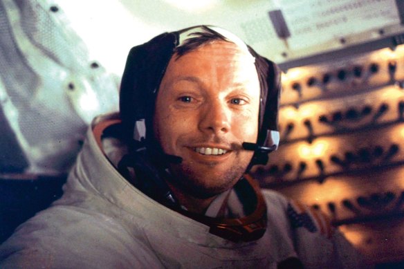 Neil Armstrong is seen smiling at the camera aboard the lunar module "Eagle".