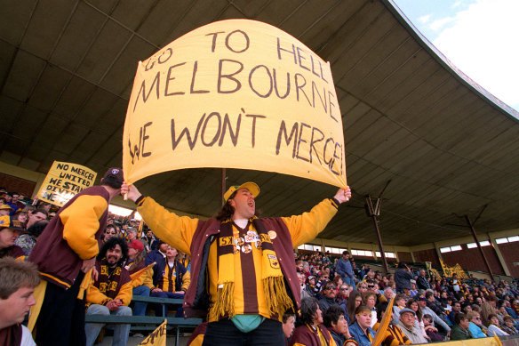 A Hawthorn fan makes his displeasure known about the proposed merger.