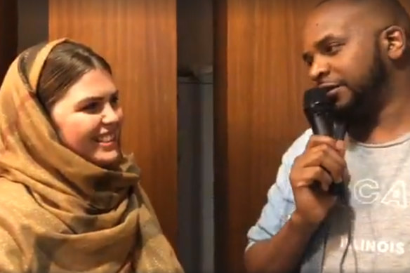 A headscarf-clad Belle Gibson goes by the name Sabontu and speaks at an Ethiopian community function in Melbourne.
