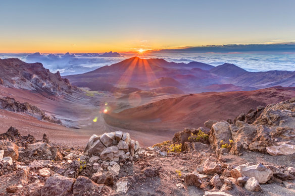 The sun rises over the summit of Hawaii's Haleakala volcano.