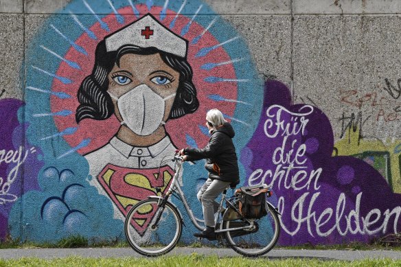 "For the real heroes": Graffiti by street artist 'Uzey' showing a nurse as Superwoman in Hamm, Germany.