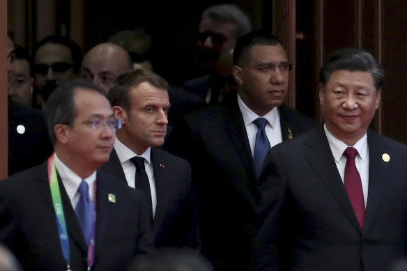 Macron, second from left, and Xi, right, were addressing the audience at a Chinese trade expo in Shanghai attended by representatives of 63 countries.