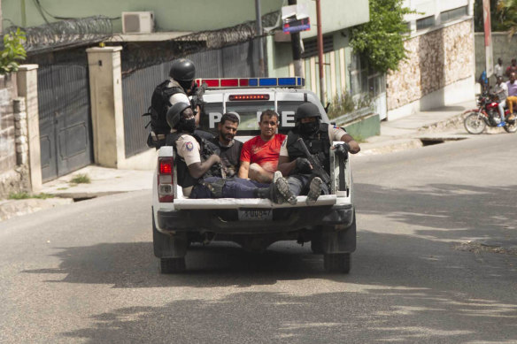 Police arrested two men and drove them away in a ute as a crowd ran after them to the nearby police station.