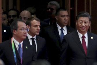 Macron, second from left, and Xi, right, were addressing the audience at a Chinese trade expo in Shanghai attended by representatives of 63 countries.