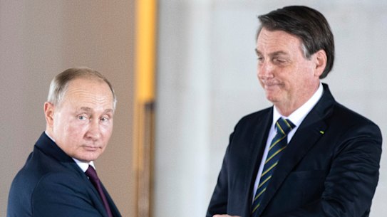 Brazilian President Jair Bolsonaro, right, welcomes Russian President Vladimir Putin to a meeting of leaders of the BRICS countries in Brasilia in 2019.