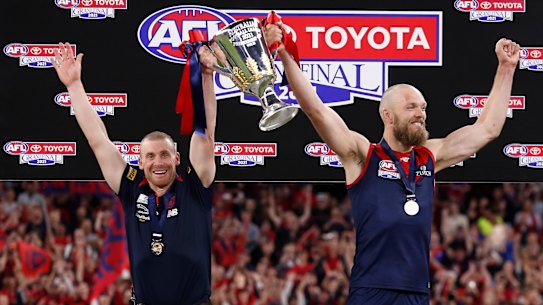 Melbourne coach Simon Goodwin and captain Max Gawn lift the premiership cup last year.