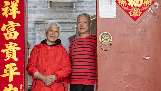 Ma Peizeng (right), 73, and his wife Wu Xiuhua, 73, at the door that opens into their shared courtyard residence in Dafangjia Hutong in east Beijing’s Dongcheng district.