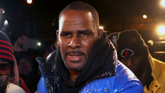 R. Kelly turns himself in at a Chicago police station after being charged with sexual abuse.