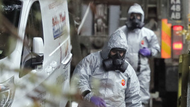 Personnel in protective gear work on a van in Winterslow, England, during investigations into the nerve-agent poisoning of Russian ex-spy Sergei Skripal and his daughter Yulia.