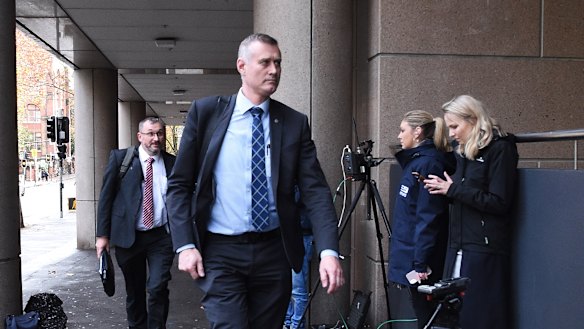 AFP officers arrive at the ABC on Wednesday.
