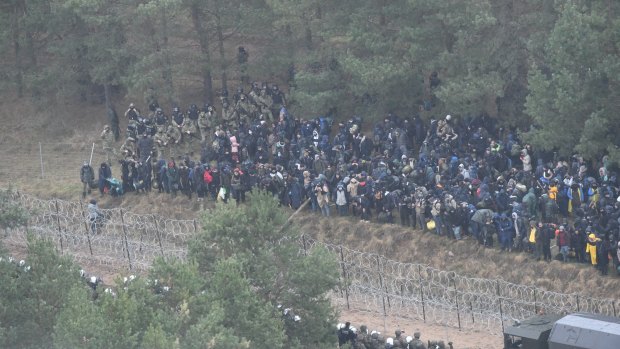 Polish border army units stand guard as migrants gather near the Kuznica border crossing on the Belarusian-Polish border.