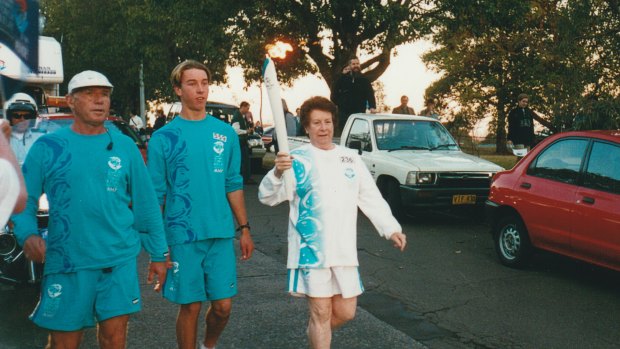 Evelyn Dill-Macky running with the Olympic torch before the 2000 Sydney Games.