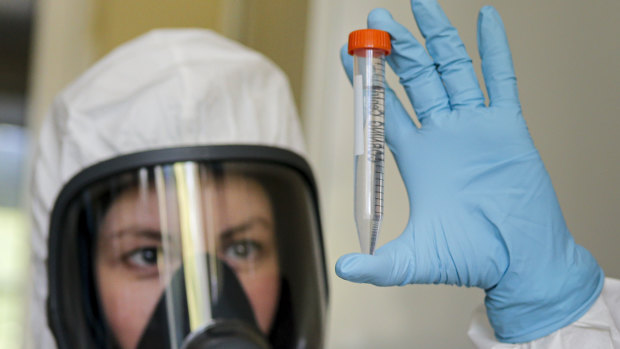 An employee shows the new vaccine at the Nikolai Gamaleya National Centre of Epidemiology and Microbiology in Moscow.