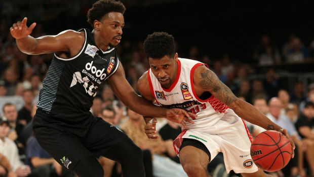 Bryce Cotton of Perth (right) contests with Casper Ware of Melbourne during the Round 18 NBL match between Melbourne United and the Perth Wildcats at Melbourne Arena in Melbourne, Sunday, February 17, 2019.