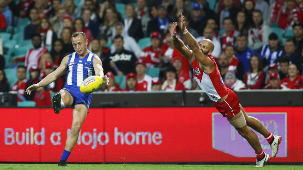 Touchy subject: Billy Hartung goes for goal as Jarrad McVeigh closes in.