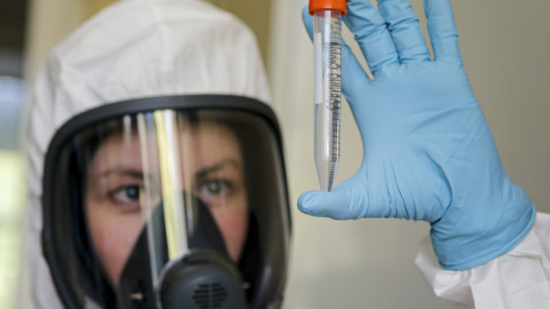 An employee shows the new vaccine at the Nikolai Gamaleya National Centre of Epidemiology and Microbiology in Moscow.