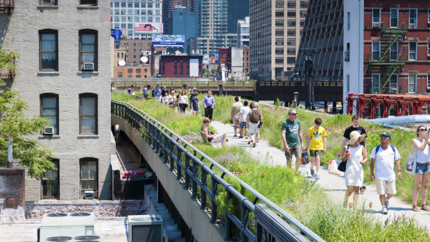 People stroll along High Line park in New York.