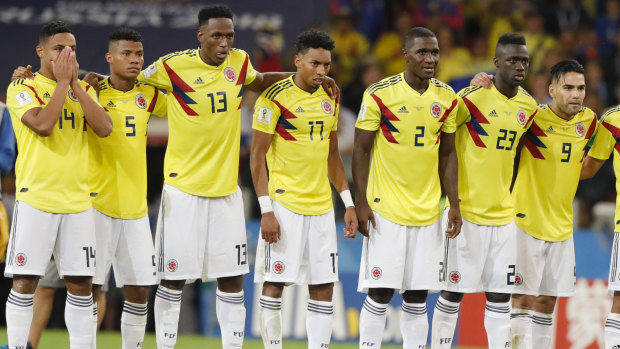 Quiet chat: Colombia's players watch on during the penalty shootout, but John Stones says they were sledging England's penalty-takers.