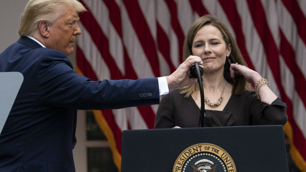 President Donald Trump adjusts the microphone after he announced Judge Amy Coney Barrett on Saturday.