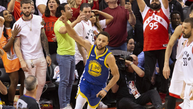 Not yet: Steph Curry celebrates after Kyle Lowry's last-second miss.