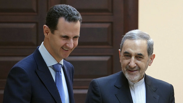 Assad, left, meeting with Ali Akbar Velayati in Damascus on Thursday.