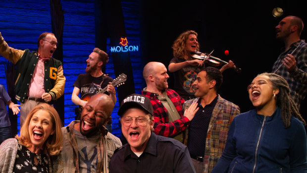 The cast of Come From Away bring to life the poignant encounters between the residents of Gander - including local cop Oz (Simon Maiden, centre) - and their international guests.