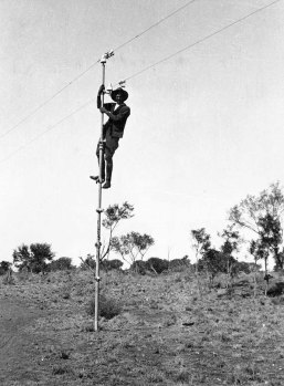 Bob Carew up a pole on the Overland Telegraph, 1921.