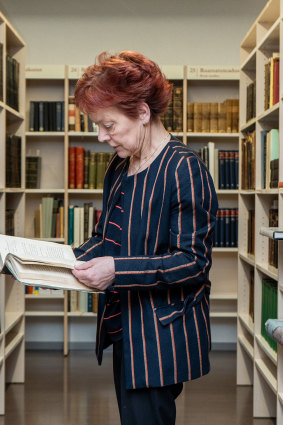 Krista Aru, the director of the Tartu University library, inspects a first edition of Gogol’s “Dead Souls,” in Tartu, Estonia, where eight books disappeared from the library.