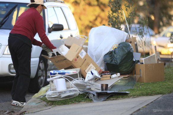 Upcyclers sift through rubbish piles prior to a council clean-up 