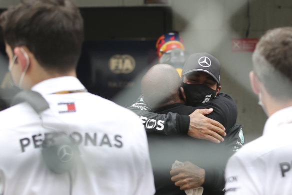 Lewis Hamilton embraces his father, Anthony Hamilton, after the Portuguese Grand Prix.