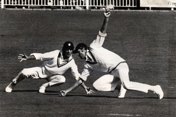 Tony Greig dives in front of Mike Brierley during the Centenary Test at the MCG.