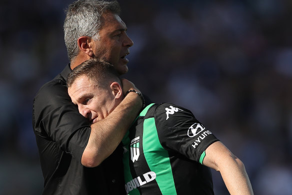 Mark Rudan hugs Besart Berisha after the striker was substituted off against Victory.