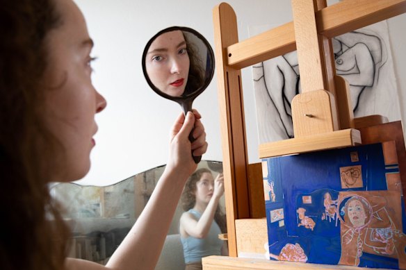 Artist Natasha Walsh, at work on her Archibald Prize entry, a riff on Brett Whiteley’s winning piece, which includes a self-portrait in a mirror.