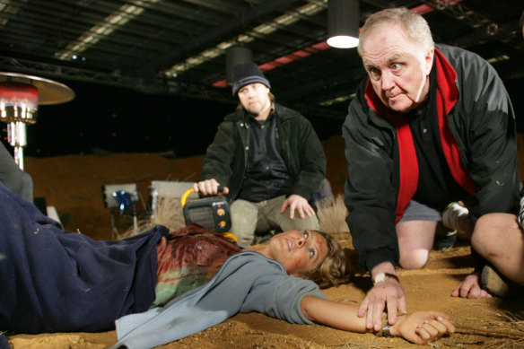 Miller (right) directs Natalie Bassingthwaighte on the set of Prey, which was set in the outback but filmed in a Melbourne warehouse due to budgetary constraints.