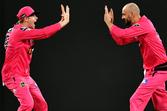 Steve Smith and Nathan Lyon celebrate the big wicket of BBL player of the season Marcus Stoinis.
