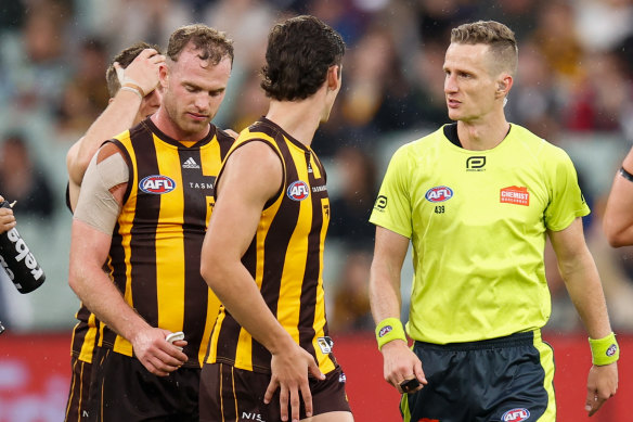 Tom Mitchell speaks with field umpire Hayden Gavine after a 50-metre penalty was awarded.