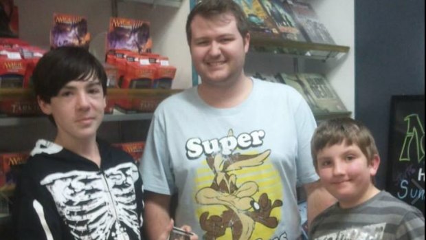 Brisbane's last video store owner Brenton Snell with customer, Remus (left) and James.