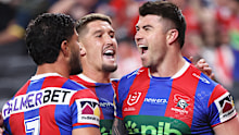 Newcastle Knights’ Bradman Best, right, is congratulated by teammates Dylan Brown, left, and Dylan Lucas.