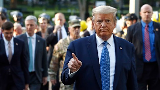 President Donald Trump returns to the White House with his security after visiting St John's Church, 200 metres away, on Monday, 