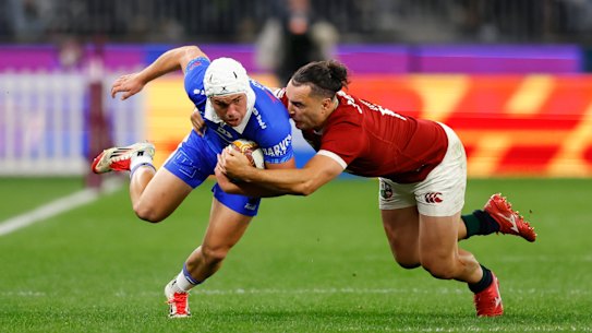 PERTH, AUSTRALIA - JUNE 28: Mac Grealy of the Force gets tackled by James Lowe of the British Lions during the tour match between Western Force and British & Irish Lions at Optus Stadium on June 28, 2025 in Perth, Australia. (Photo by James Worsfold/Getty Images)