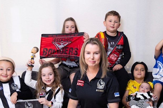Casey Nunn with young football fans (from left) Molly, Chloe, Charlotte, Lachlan, Levi (holding baby Millie) and Andre.