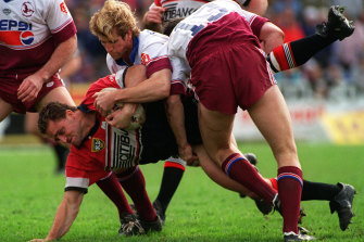 North Sydney enforcer Billy Moore is driven into the Brookvale turf by Manlyâ€™s Des Hasler in 1995.