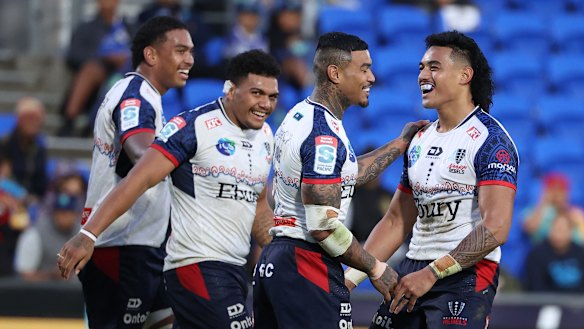 David Feliuai (right) celebrates with Rebels teammates.